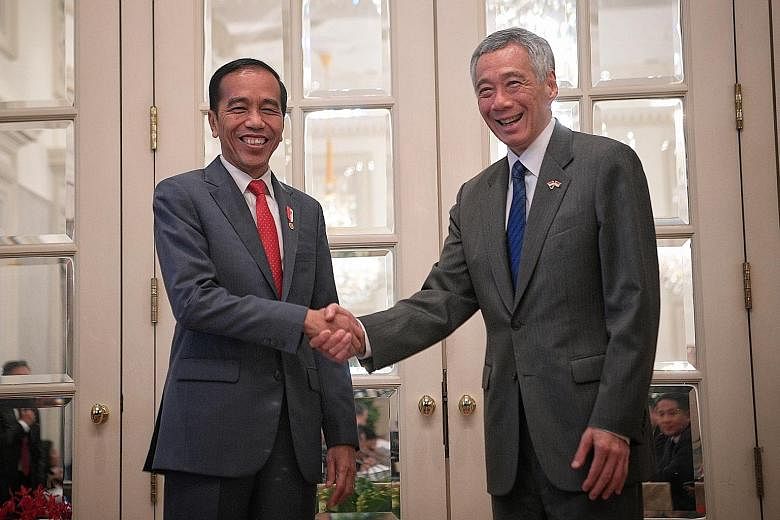 Indonesian President Joko Widodo calling on PM Lee ahead of the Singapore-Indonesia Leaders' Retreat, which was held at the Istana on Oct 8. PM Lee also attended Mr Joko's inauguration in Jakarta that month. 