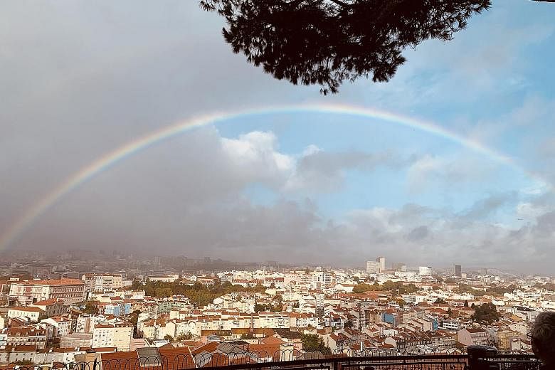 Cruising on the Peace Boat from Reykjavik to Lisbon, the writer saw the aurora borealis, or the Northern Lights, from the ship and a rainbow (left) over Lisbon from the Miradouro de Senhora do Monte, the highest point in the Portuguese city. Dr Willi