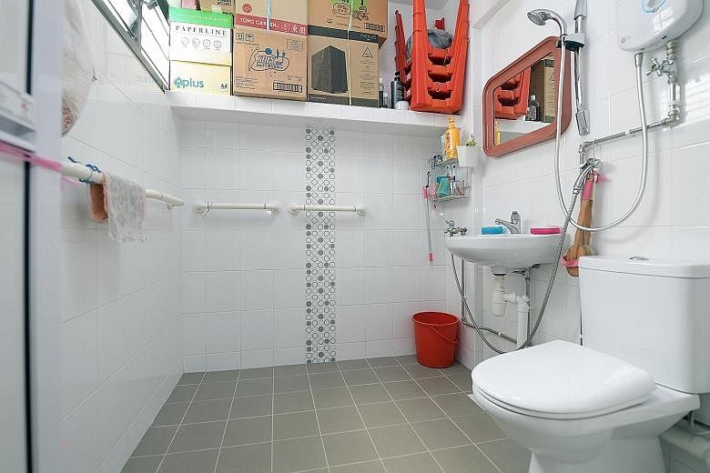 Above: Madam Kwan Kum Lai and her husband, Mr Chan Meng Kwong, had their Hougang flat upgraded in April under the Home Improvement Programme and the Enhancement for Active Seniors scheme. Below: Grab bars in the toilet and slip-resistant treatment fo