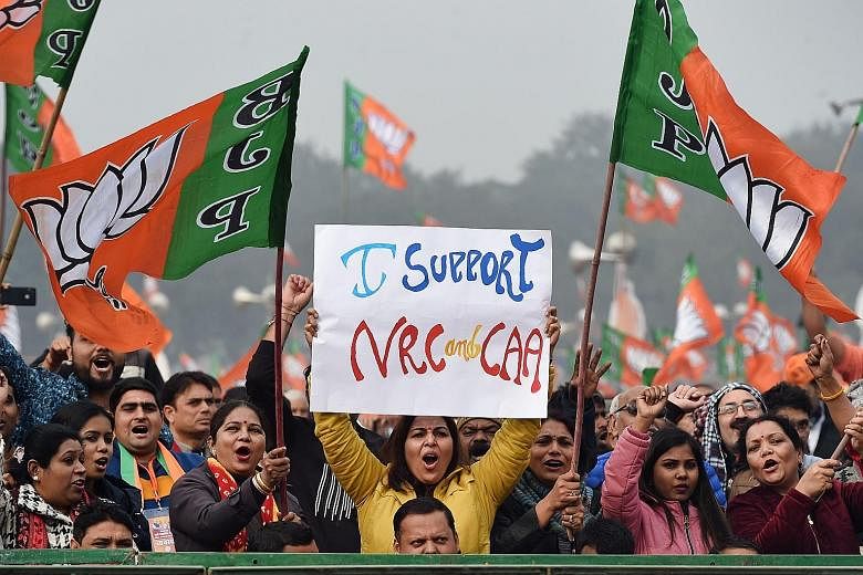 Supporters of Indian Prime Minister Narendra Modi's Bharatiya Janata Party at a rally in New Delhi yesterday in support of the government's Citizenship Amendment Act and the National Register of Citizens.