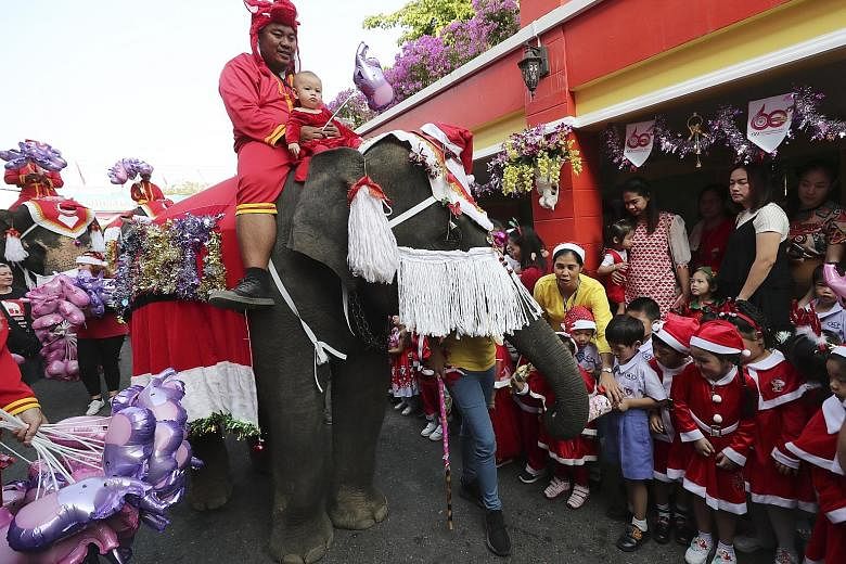 Elephants dressed as Santa Claus gave out presents and candy to pupils in Thailand yesterday in an annual Christmas tradition in the mostly Buddhist country. The Christmas celebration at Jirasartwitthaya School in Ayutthaya, north of Bangkok, has run