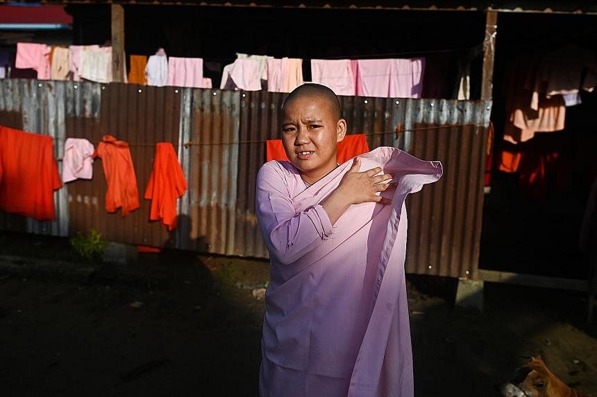 Buddhist nuns from the Mingalar Thaikti nunnery collecting alms in Yangon. All of the nunnery's 66 girls were born in an area of Shan state plagued by conflict between local rebel groups and the military. Teenager Dhama Theingi said her parents sent 