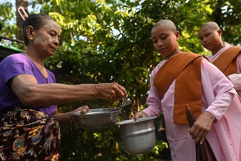 Buddhist nuns from the Mingalar Thaikti nunnery collecting alms in Yangon. All of the nunnery's 66 girls were born in an area of Shan state plagued by conflict between local rebel groups and the military. Teenager Dhama Theingi said her parents sent 