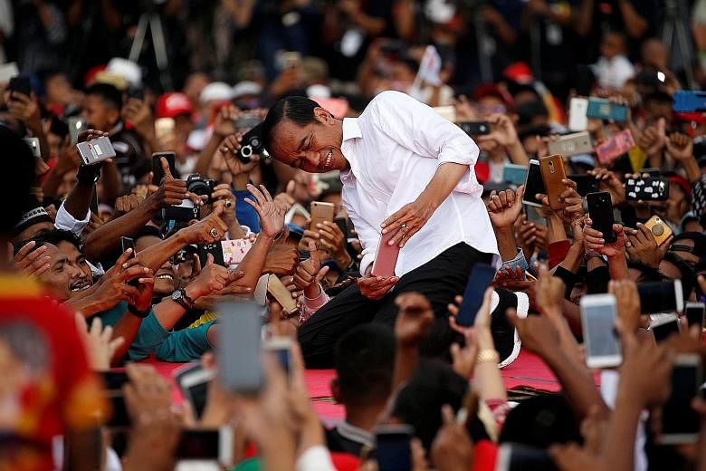 Indonesia's President Joko Widodo (left) and Thailand's Prime Minister Prayut Chan-o-cha on the campaign trail earlier this year. Both were returned to office. Mr Joko will now have to face the challenge of balancing economic growth with socio-cultur