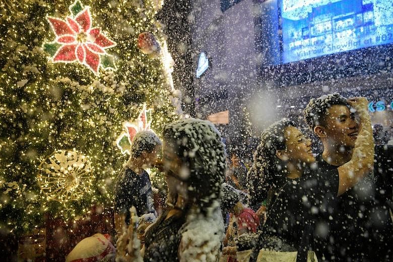 It has been snowing at Tanglin Mall, and even though it is just artificial snow, it brings on the smiles as people enjoy the 15-minute segment of the mall's Christmas celebrations, Garden Wonderland. Members of the public can experience the "snow" on