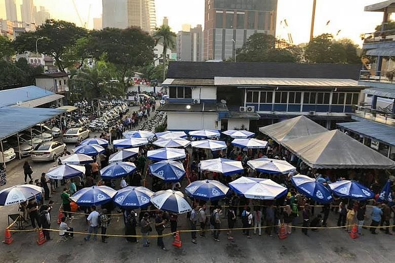 The queue to settle traffic summonses at Dataran JSPT Kuala Lumpur yesterday. Malaysian police, who periodically give steep discounts on tickets issued for traffic offences such as speeding, this year picked Christmas Eve and Boxing Day as the days f