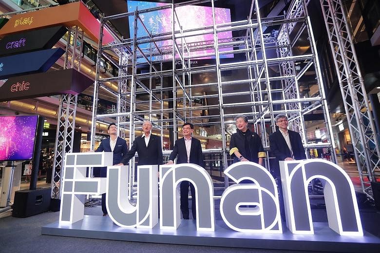 A robot-controlled collection point will allow customers to retrieve their purchases from the mall at any time. The 24-hour service will be trialled with GamePro Shop, Alan Photo and T K Foto in the first quarter of next year. (From left) Funan centr