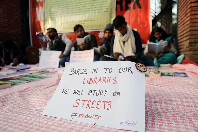 Students outside the Jamia Millia Islamia University in New Delhi protesting against India's new controversial citizenship law on Thursday. PHOTO: REUTERS