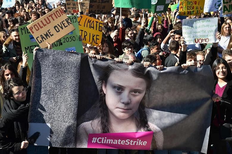 Climate activists in Rome earlier this year with placards and a banner featuring 16-year-old Swedish Greta Thunberg, who says the world's leaders have failed to act decisively to cut greenhouse gas emissions that are heating up the planet and that yo