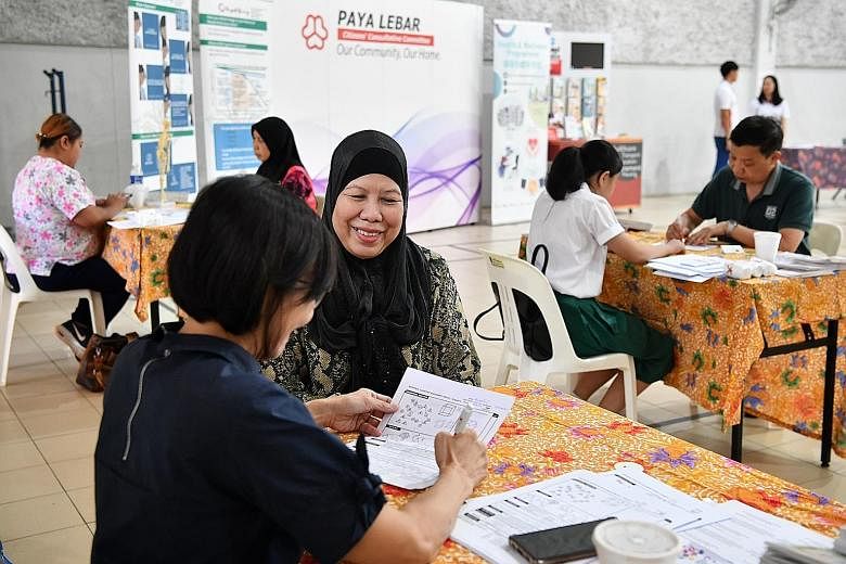 Residents (right) testing for cognitive impairment at Paya Lebar Kovan Community Club as part of the health and wellness programme yesterday. The programme is an initiative by Aljunied GRC Grassroots Organisation (Paya Lebar) and its adviser Alex Yeo