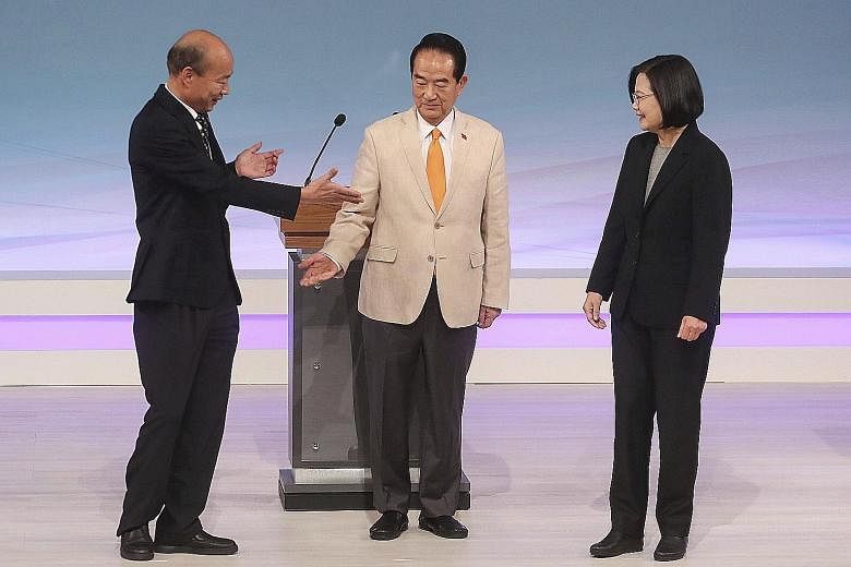 From left: Mr Han Kuo-yu from the Kuomintang, People First Party chairman James Soong and President Tsai Ing-wen of the Democratic Progressive Party before the start of their televised debate in Taipei yesterday. Taiwan will hold its general election