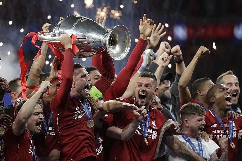 Liverpool players lifting the Champions League trophy in June. The Reds went on to win the Uefa Super Cup and the Club World Cup, becoming the first English club to clinch that treble. 