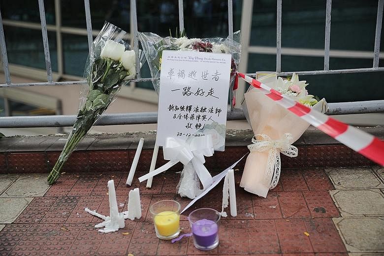 Above: Flowers left at the accident site yesterday. ST PHOTO: GIN TAY Left: Foreign Minister Vivian Balakrishnan and Senior Parliamentary Secretary for Manpower Low Yen Ling visiting one of the victims in hospital yesterday. PHOTO: LOW YEN LING/FACEB