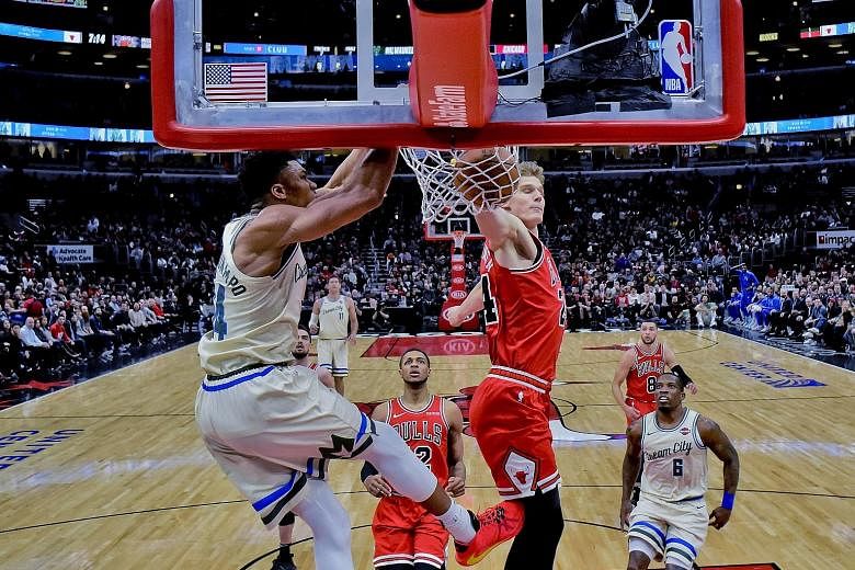Giannis Antetokounmpo dunking against Bulls' Lauri Markkanen. The Bucks star scored some flashy baskets on his return from injury. PHOTO: ASSOCIATED PRESS
