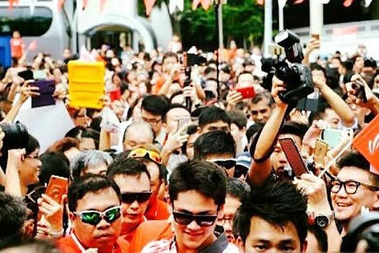 Left: Mr Edwin Cheong (front, in green sunglasses) providing protection services to swimmer Joseph Schooling during a victory parade in 2016 after the latter's Olympic win. PHOTO: FRANCIS CHNG Above: Ms Wendy Hon was part of the team protecting rock 