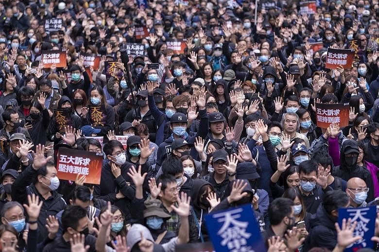 Protesters in Hong Kong's Hennessy Road yesterday. Demonstrators rang in the new year with a mass march through downtown areas.