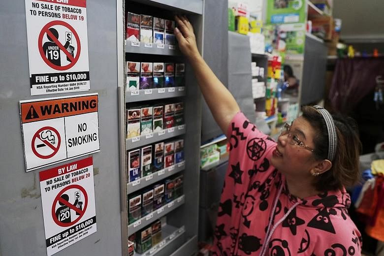 Madam Sherley Ang, 54, owner of Hianky Provision Store, which displays both the new and old notices on the minimum legal age for purchasing tobacco. ST PHOTO: KELVIN CHNG