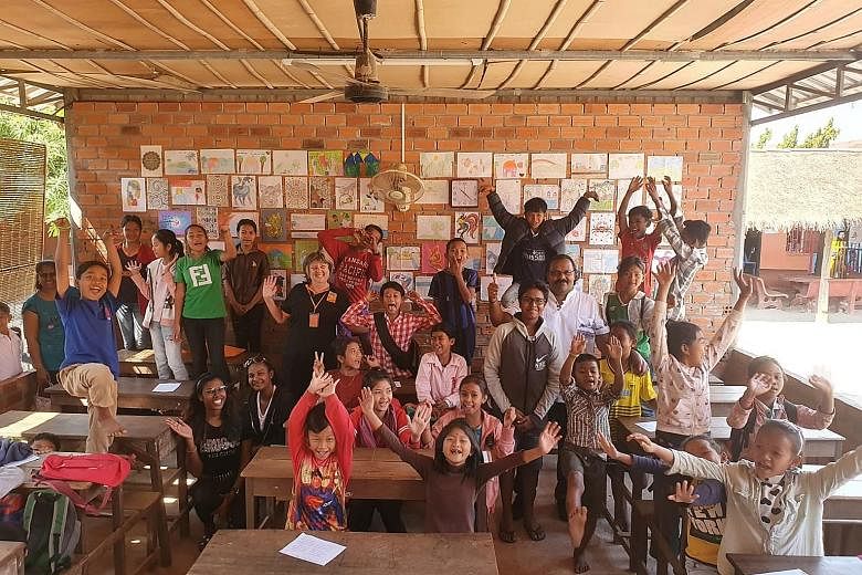 Mr Kevin Raja (in white shirt) and his family with the children and staff of a community school run by non-profit charity Feeding Dreams Cambodia in Siem Reap last month.