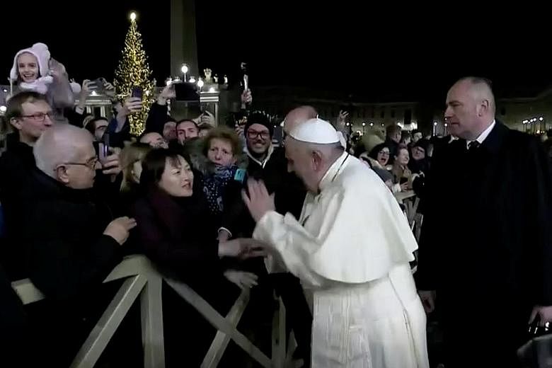 A still image taken from a video showing Pope Francis slapping away the hand of a woman who had grabbed him at St Peter's Square at the Vatican on Tuesday.