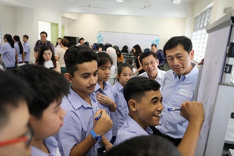 Above: Education Minister Ong Ye Kung visiting a Secondary 1 form class with students from different streams at Ping Yi Secondary School yesterday. Below, from left: Ping Yi Sec 1 student Zayeed Ibrahim, who is in a form class with students from othe