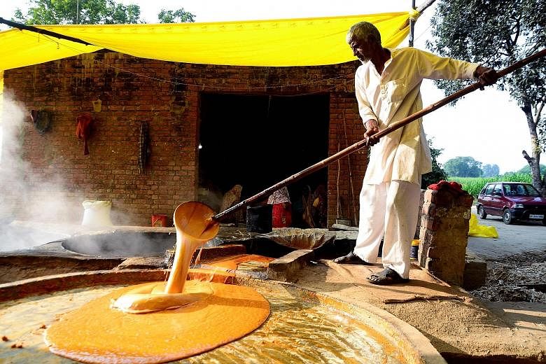 A worker at a jaggery factory in Fatehpur, India. India's manufacturing PMI rose to 52.7 last month, from 51.2 in November.