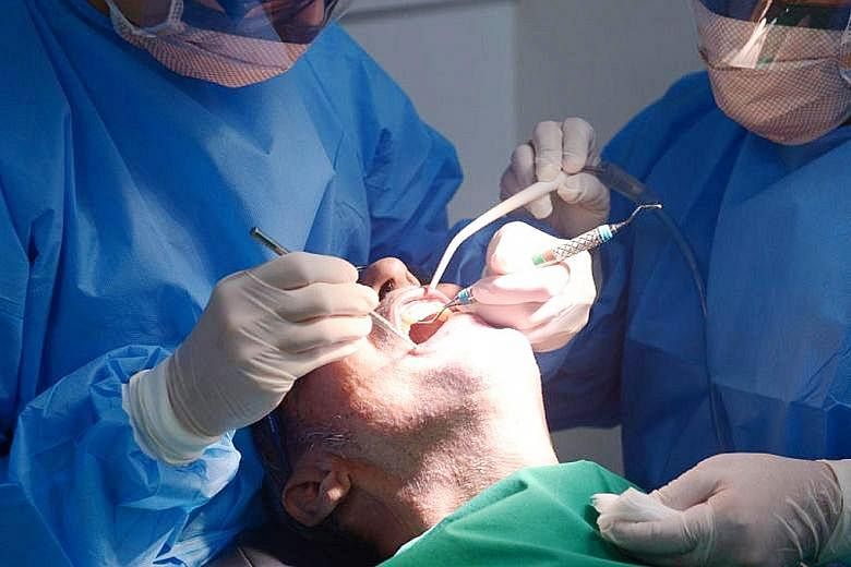 A patient in the dentist's chair. The writer, referring to another case, about a dentist who had pulled a woman's tooth and replaced it with an implant, says what was at stake there was just a tooth, but important still, to the patient. Even more so 