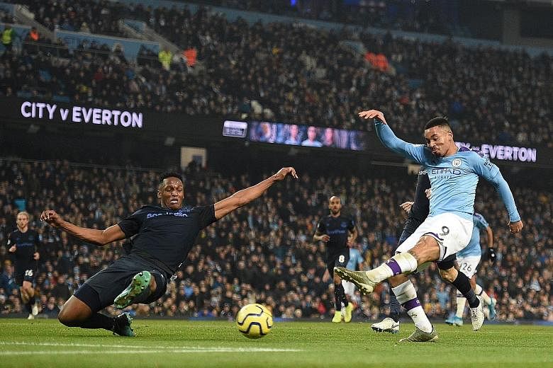 Manchester City striker Gabriel Jesus shooting to score their second goal against Everton in the Premier League on Wednesday. It was his seventh goal against the Toffees in five appearances. PHOTO: AGENCE FRANCE-PRESSE