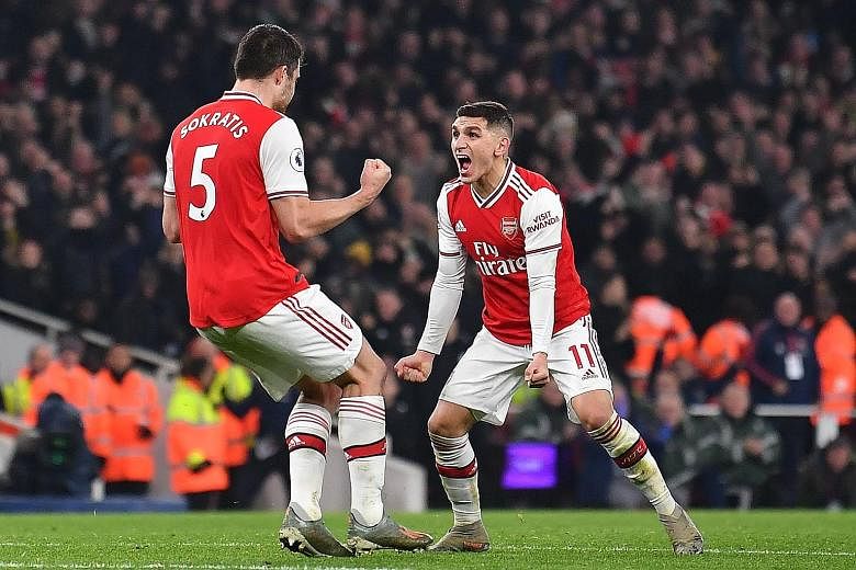 Defender Sokratis Papastathopoulos celebrating with Lucas Torreira after scoring Arsenal's second goal against Manchester United in the Premier League on Wednesday. PHOTO: AGENCE FRANCE-PRESSE