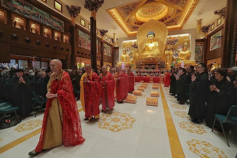 (From left) Venerable Heng Sure, Venerable Yongshou, Venerable Juexing, Venerable Xinguang, Venerable Pu En and Venerable Yanxu conducting the consecration ceremony yesterday for the Singapore Buddhist Lodge's new worship hall and golden Buddha statu