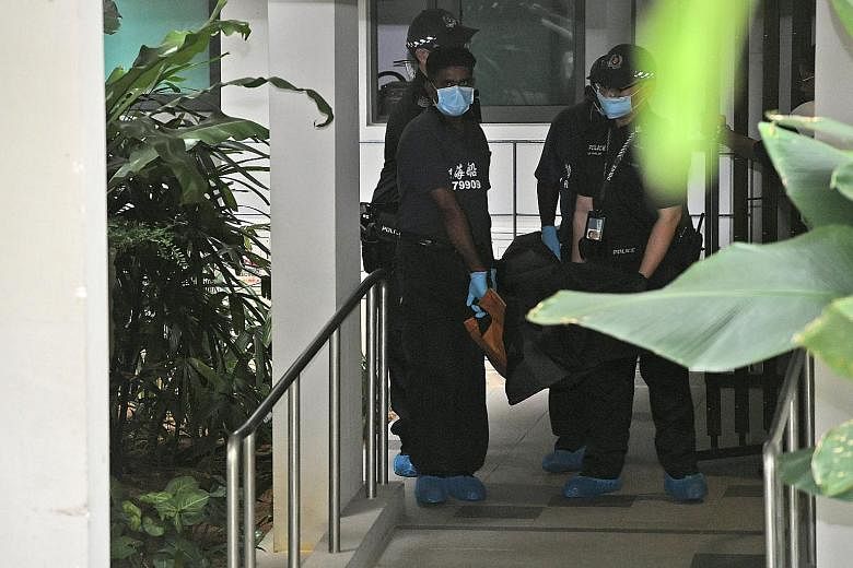 The body of the woman being taken away from the scene yesterday. Residents at the Sengkang condominium had witnessed her arguing with a man before her death.