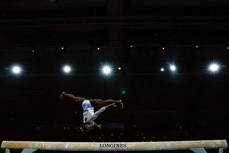 American Simone Biles performing on the balance beam at the FIG Artistic Gymnastics World Championships last year. She dominated the competition, winning five golds and missing out only on the uneven bars. 