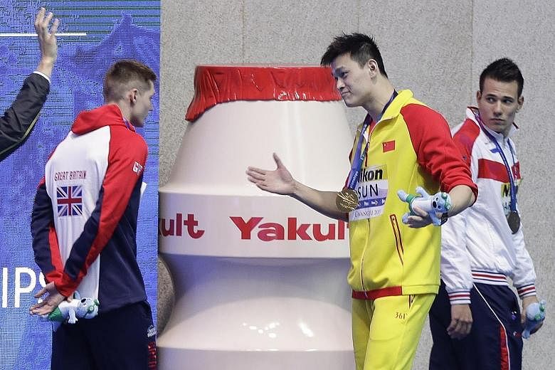 Briton Duncan Scott refusing to pose with 200m freestyle champion Sun Yang on the podium at the world championships in South Korea last July. The snub was over the Chinese star's row with doping testers in September 2018 that led to a smashed blood vial.