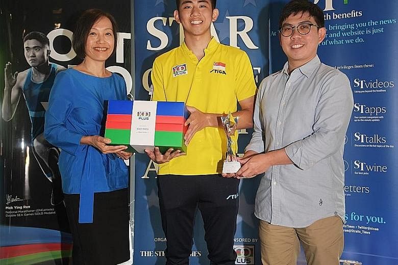 The Straits Times Star of the Month award winner for December Koen Pang with Jennifer See, managing director of F&N Foods, and Jonathan Wong, The Straits Times assistant sports editor, yesterday. ST 