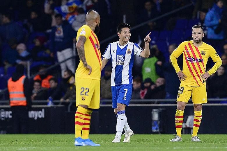 Espanyol's Chinese forward Wu Lei celebrating his 88th-minute equaliser in the home's side 2-2 draw against Barcelona. The result enabled Real Madrid to pull level with Barca at the top of the table, behind only on goal difference, after a 3-0 win at
