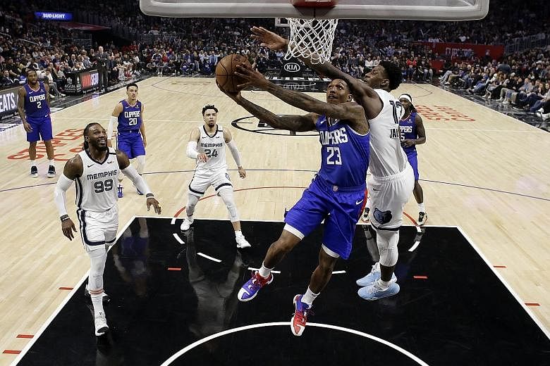 Lou Williams driving to the basket despite the attention of Memphis Grizzlies' Jaren Jackson Jr. The guard scored 24 points but was unable to prevent the LA Clippers from a humbling 140-114 loss at the Staples Centre on Saturday night.