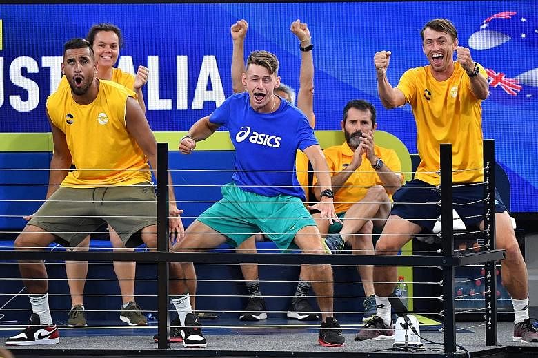Team Australia players (from left) Nick Kyrgios, Alex de Minaur and John Millman cheering teammates Chris Guccione and John Peers during their doubles match against Felix Auger-Aliassime and Adil Shamasdin of Canada yesterday.