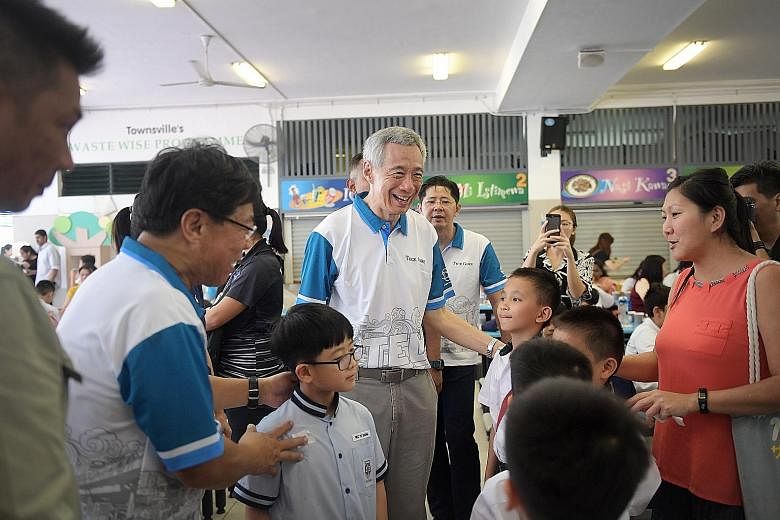 Prime Minister Lee Hsien Loong meeting award recipients and their families at the award ceremony on Saturday at Townsville Primary School. The Teck Ghee CCC Bursary was awarded to 351 students, while another 760 received the MOE Edusave Awards.
