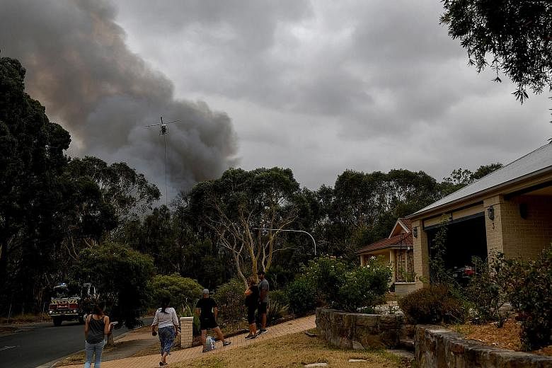 Residents staying vigilant as bush land burns in Sydney, Australia. Hundreds of fires continued to burn across the country yesterday. PHOTO: EPA-EFE