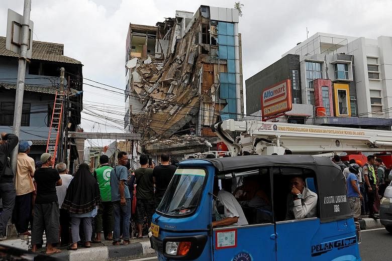 The five-storey building that partially collapsed in Jakarta yesterday is a mixed residential-commercial space. Indonesia's search and rescue agency says recent downpours in the capital may have played a role in the collapse. Says the agency's nation