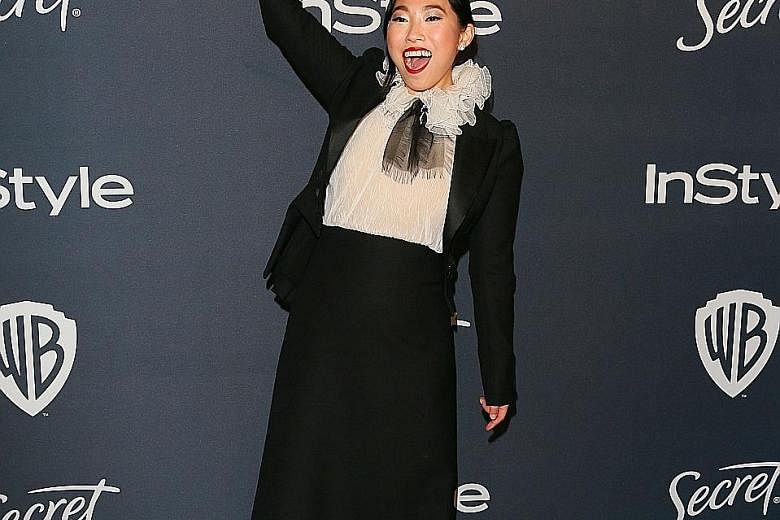 Actress Awkwafina with her award for Best Actress in a Motion Picture - Musical or Comedy.