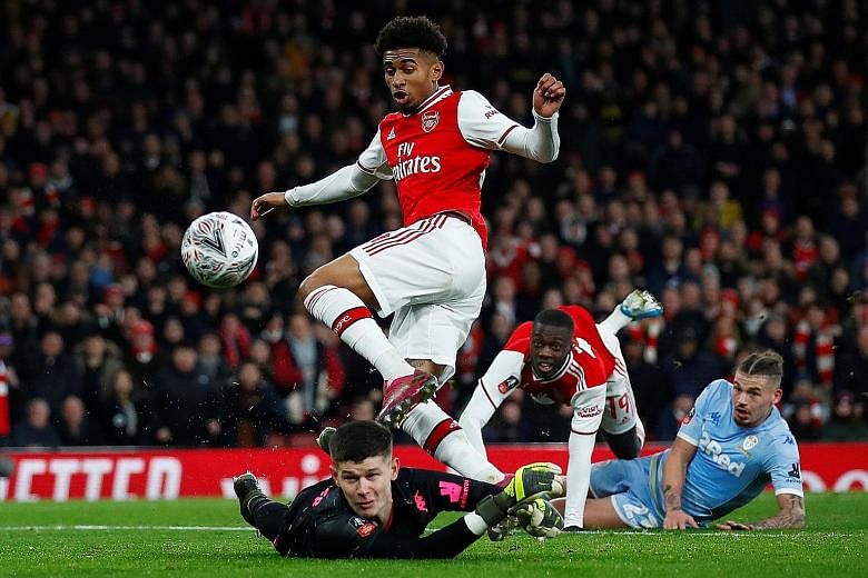 Reiss Nelson scoring during the 1-0 FA Cup third-round win over Leeds on Monday. Arsenal, who will face Bournemouth next, improved after a difficult first half. PHOTO: REUTERS