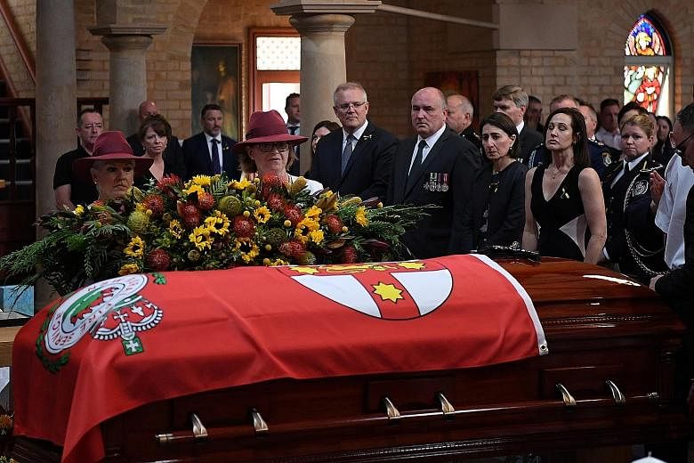 Australian Prime Minister Scott Morrison (centre), New South Wales (NSW) Emergency Services Minister David Elliott and NSW Premier Gladys Berejiklian (next to Mr Elliott) at the funeral service of NSW Rural Fire Service volunteer Andrew O'Dwyer in Sy