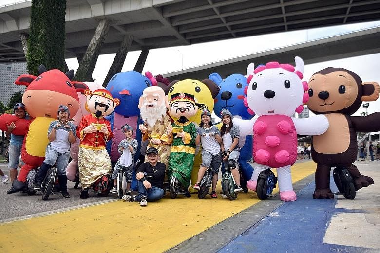 Members of the electric unicycle community, The Wheelies, decked out in some of the costumes they will be wearing at this year's Chingay parade. The 2m-tall inflatable costumes include the 12 animals of the Chinese horoscope and four deities - God of