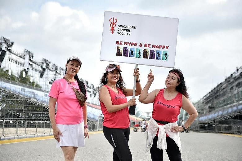Ms Ramlah De Rose flanked by two members of Be Hype & Be Happy, Ms Kelly Ang (left) and Ms Joanna Tan, at last Saturday's rehearsal. The group comprises 27 cancer patients and survivors aged between 47 and 72.