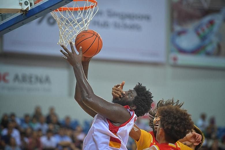 Slingers centre Anthony McClain attempting to score in the face of suffocating defence by the Saigon Heat. He finished with 11 points, 13 rebounds and five blocks but the Heat's Christien Charles won the battle of the big men with 25 points and 13 re