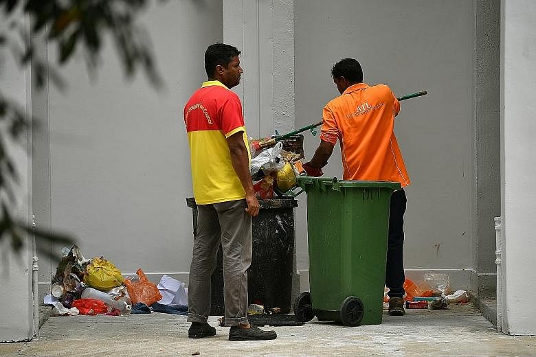 APRIL 2011: The rooftop garden in Eunos where a baby boy was found buried alive. SHIN MIN FILE PHOTO JANUARY 2020: Cleaners putting back the contents of a rubbish chute bin at Block 534 Bedok North Street 3 after it had been checked by investigators.