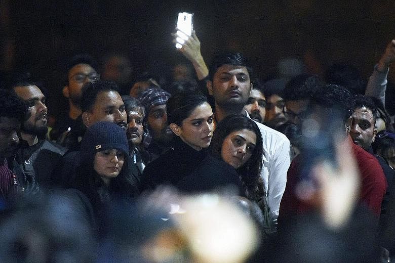 Bollywood A-lister Deepika Padukone (centre) standing behind students chanting anti-government slogans at Jawaharlal Nehru University. They were protesting against a recent attack by masked men at the university which injured some 30 people.