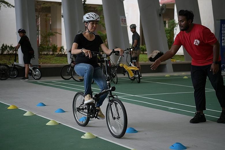 A former e-scooter rider participating in a safe riding programme organised by NTUC in an open area near GrabFood's e-Scooter Trade-In Grant Centre yesterday.