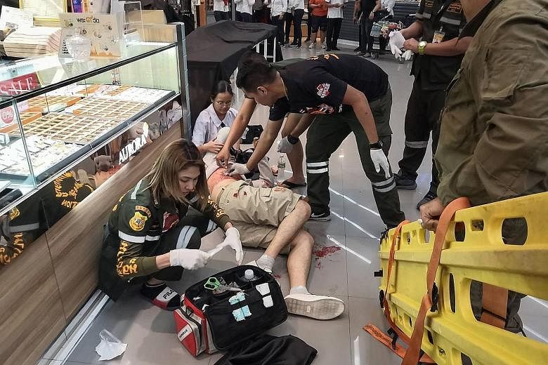 Paramedics helping a man wounded by the gunman.