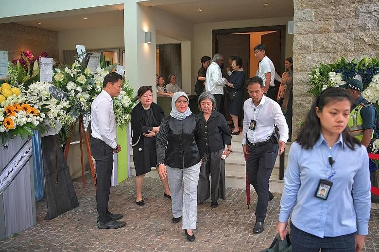 Chief Justice Sundaresh Menon arriving at the wake with his wife. He described Mr Yong as having "a wonderful heart for the people who worked with him". Ms Phyllis See (centre, in white), speaking to reporters at the wake yesterday. Ms See, 71, was s